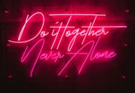 Naming an AI company: choosing a distinctive brand name that stands out, represented by an illuminated neon sign